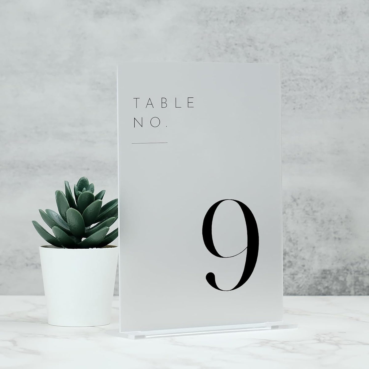 jinmury frosted wedding table numbers 1-15 with stands on a desk or shelf