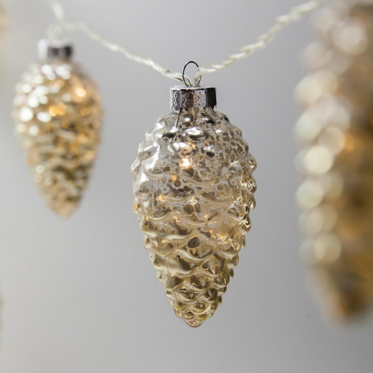 Wintergreen Lighting 6’ Mercury Glass Gold Star Lights/Gold Glass Pinecone String Lights – LED Lights String, Battery Operated, 10 Warm White LED Lights on Clear Wire (10 Pinecone Lights)