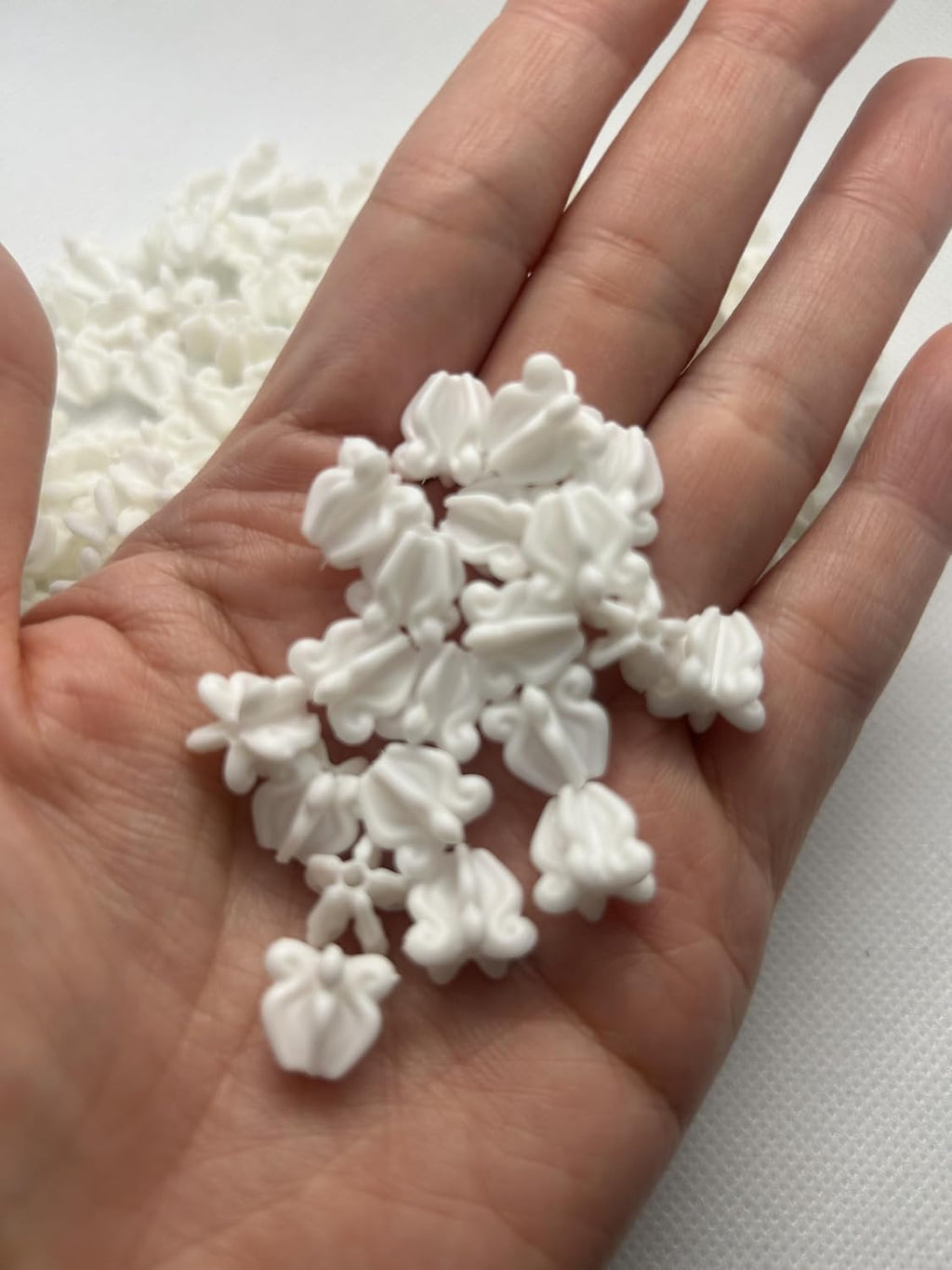 small plastic crown flower beads for jewelry making shown in use