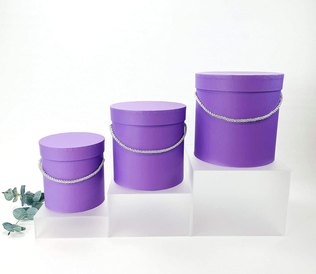 unikpackaging premium quality round flower box, gift boxes on a desk or shelf