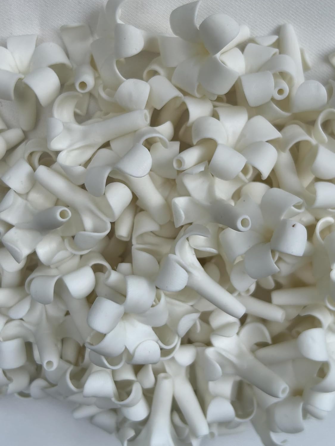 small puakenikeni (02) clay beads for jewelry making shown in use