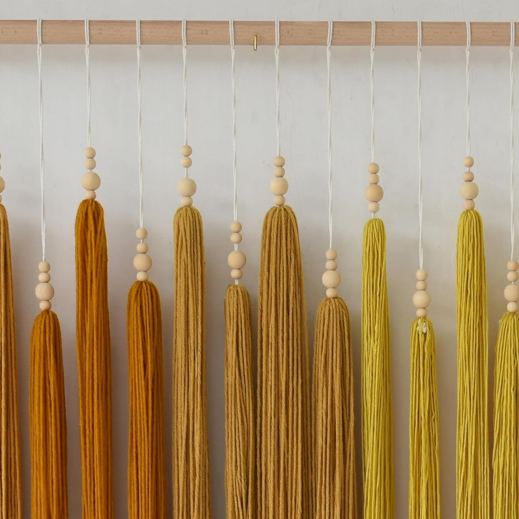 iower macrame wall hanging beaded tassel yarn art on a desk or shelf