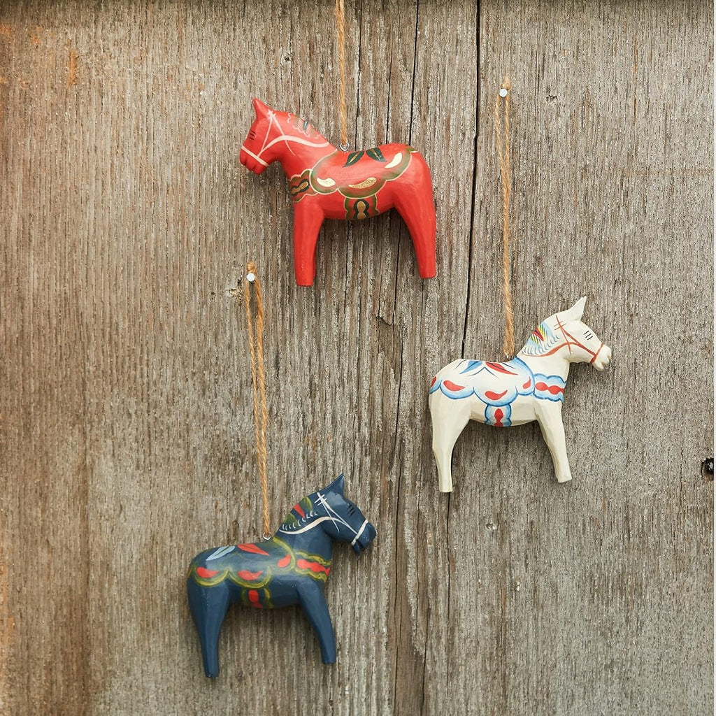 wood carved dala red white & blue horses, close-up detail